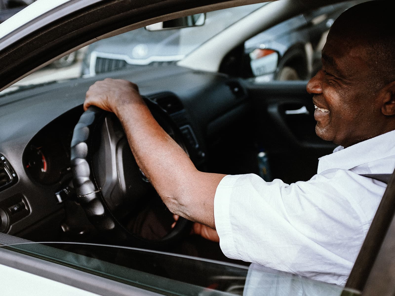 A smiling driver at the wheel